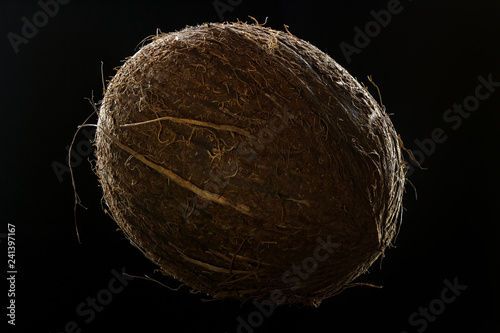Whole ripe coconut close up with a well pronounced texture