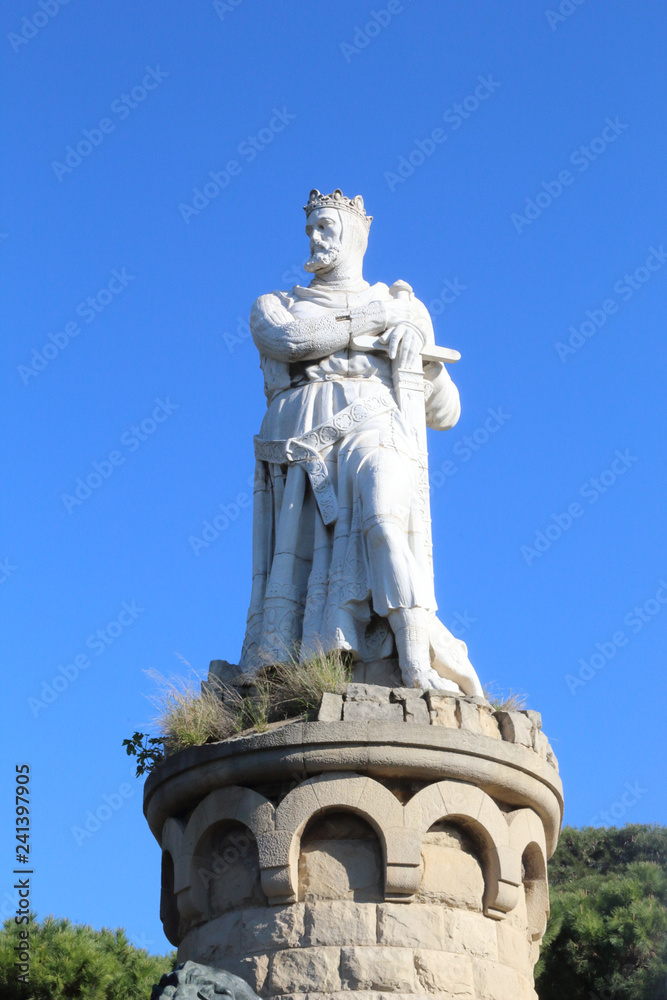 The concrete white statue of Alfonso the Battler, king of Aragon kingdom, dressed as a knight, in the Parque Grande city park in Zaragoza, Spain