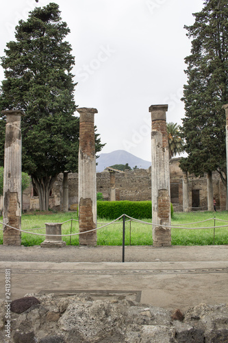 View to Vesuvius from ancient ruined Italian Roman Pompei, vertical columns, walls