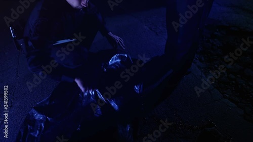Policemen walking to murder scene, writing report, taking photo of victim