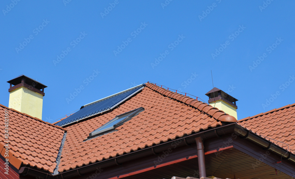 Lightning rod on rooftop. House roof lightning protection systems with attic skylight and solar water heater Lightning rod on rooftop. House roof lightning protection systems with attic skylight and solar water heater