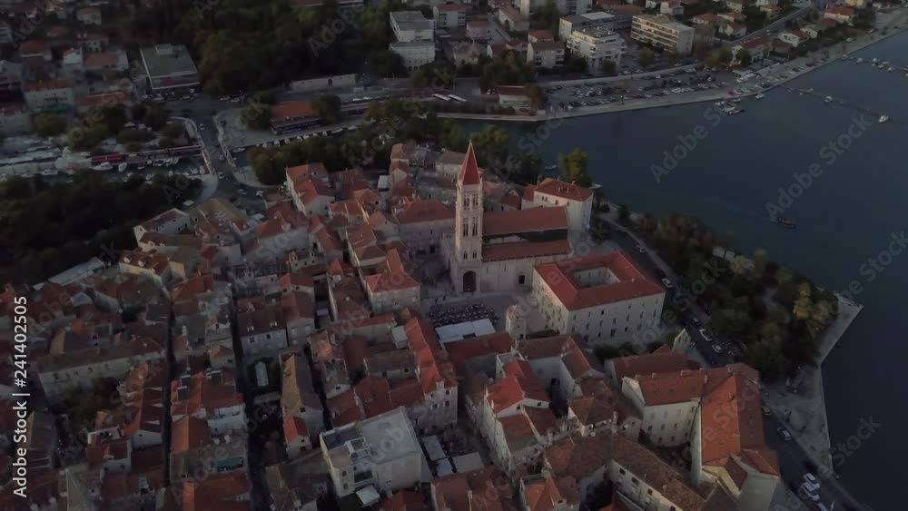 Drone goes around historical medieval church in Trogir, Croatia in summer at orange sunset. On the coast of the Adriatic sea. Drone goes around historical medieval church in Trogir, Croatia in summer at orange sunset. On the coast of the Adriatic sea.