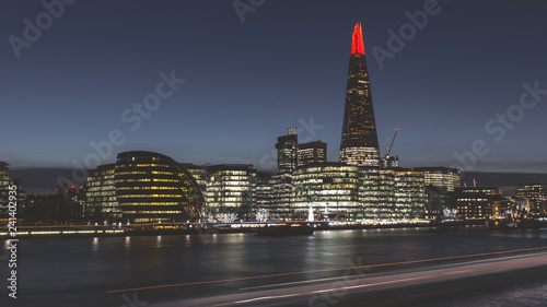 Modern London city skyline at night on River Thames shard building