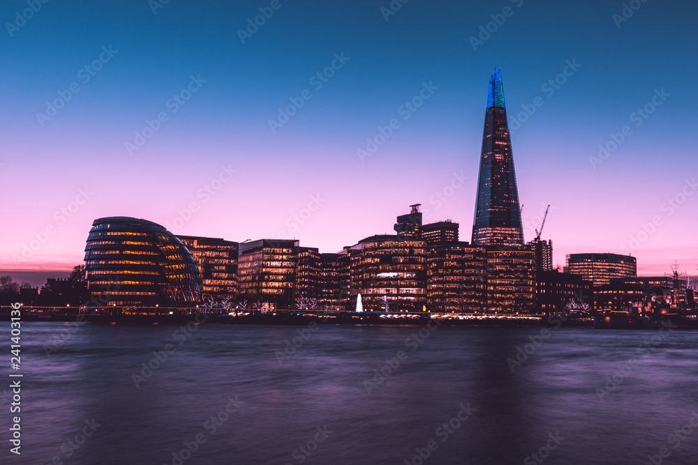 Modern London city skyline sunset on River Thames shard building