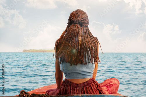 Sexy traveler woman on boat backview.