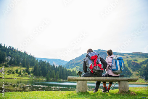 young couple of backpackers near the lake in mountains © FS-Stock