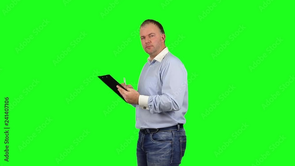 Businessman using write board to check project on a Green Screen, Chroma Key. Businessman using write board to check project on a Green Screen, Chroma Key.