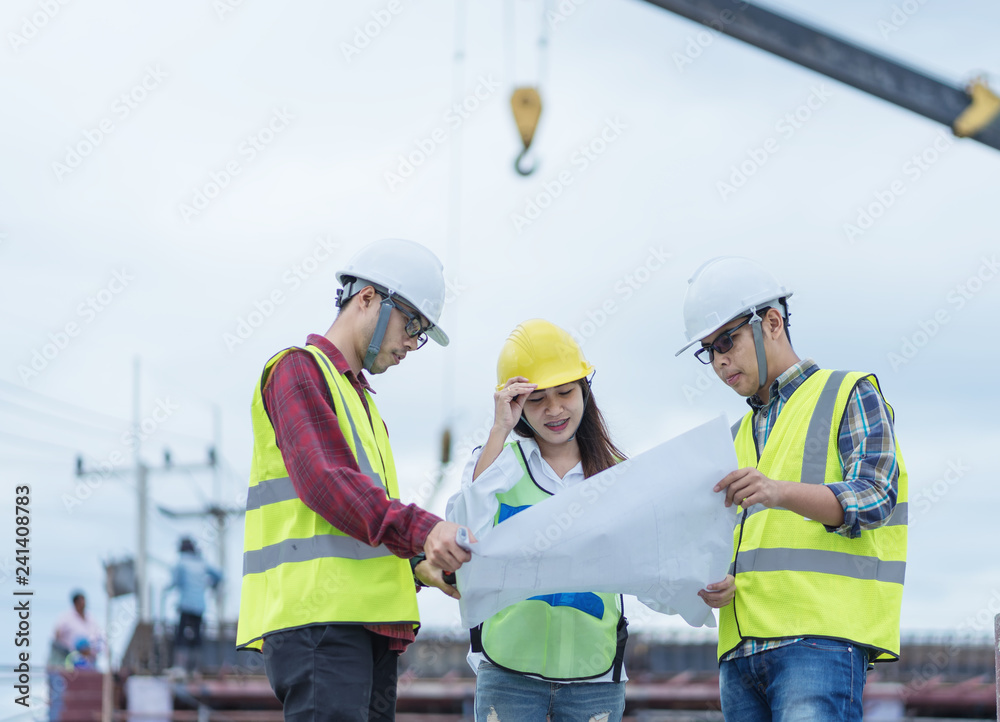 surveyor engineer with theodolite at construction site during surveying work.engineer and architect working at construction site with blueprint surveyor engineer with theodolite at construction site during surveying work.engineer and architect working at construction site with blueprint