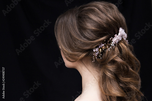 portrait of an attractive young woman with a wedding hairstyle. Back view.