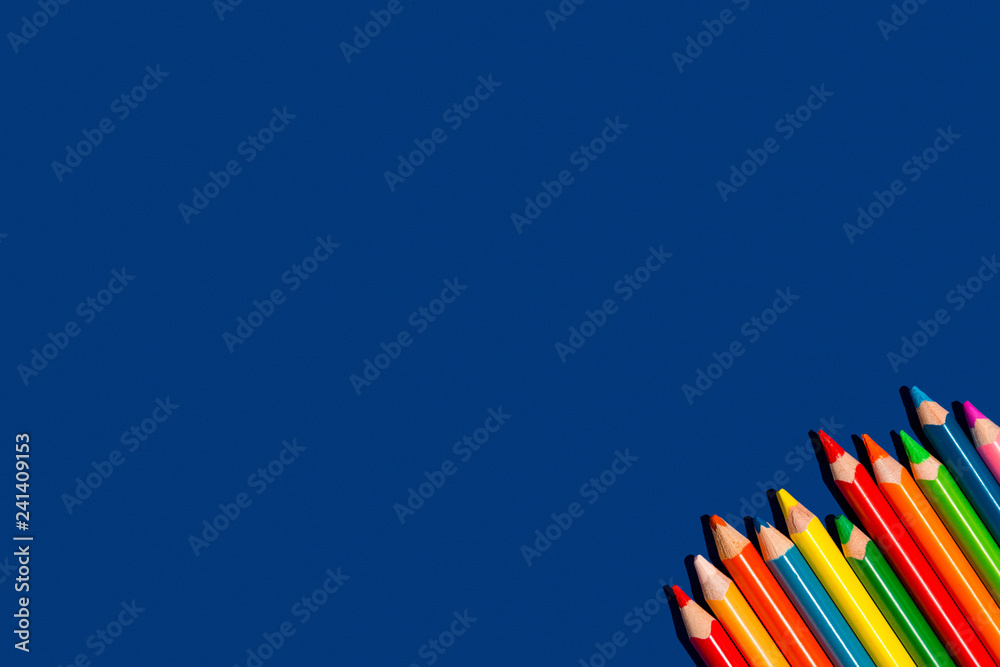 Fototapeta premium Colorful pencils on blue backgorund.