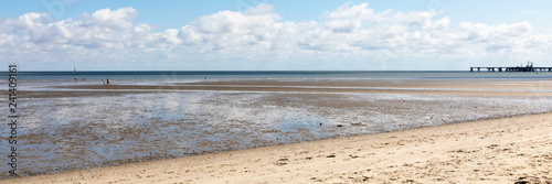 north sea beach with blue sky and clouds