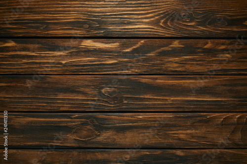 top view of dark brown wooden background with horizontal planks