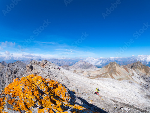 Border region Italy Switzerland, man riding mountain bike on trail at Piz Umbrail photo