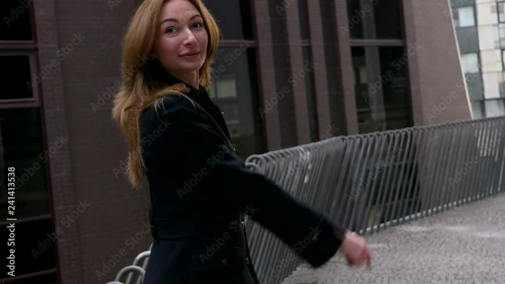 Young woman merrily spin on the street Young woman merrily spin on the street
