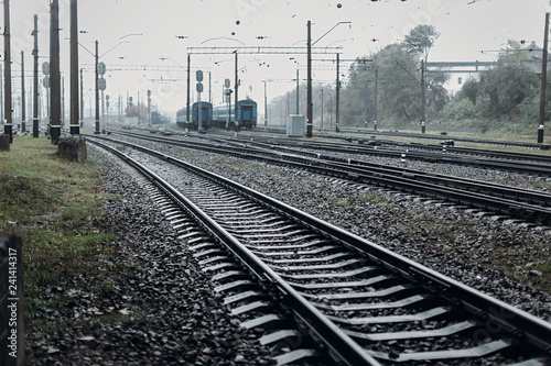 railway tracks. transportation roads and platform with carriage. foggy rainy atmosphere on railroad.