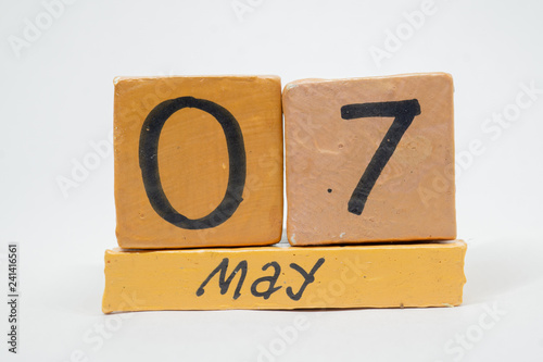 may 7th. Day 7 of month, handmade wood calendar isolated on white background. Spring month, day of the year concept