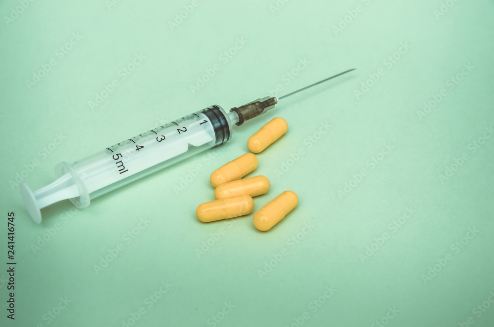 syringe and pills are on the table, medical supplies are on the table syringe and pills are on the table, medical supplies are on the table