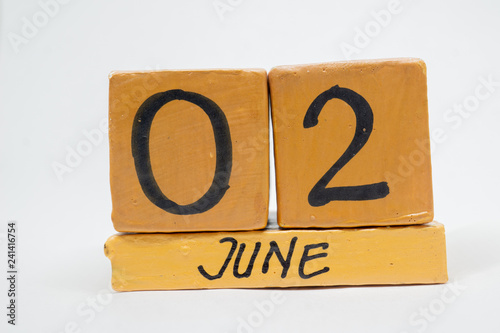 june 2nd. Day 2 of month, handmade wood calendar isolated on white background. summer month, day of the year concept