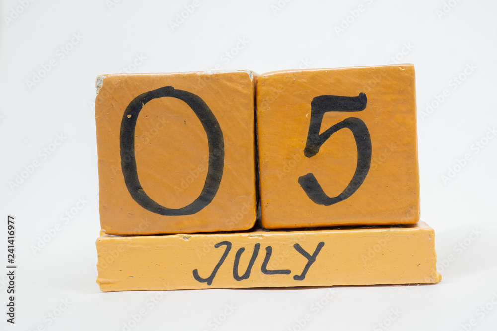 july 5th. Day 5 of month, handmade wood calendar isolated on white background. summer month, day of the year concept july 5th. Day 5 of month, handmade wood calendar isolated on white background. summer month, day of the year concept
