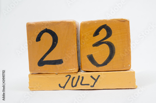july 23rd. Day 23 of month, handmade wood calendar isolated on white background. summer month, day of the year concept