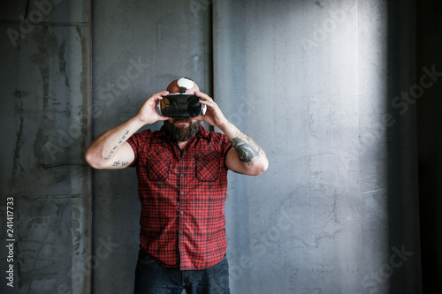 Bearded man wearing VR glasses