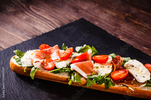 Long sandwich on black stone plate