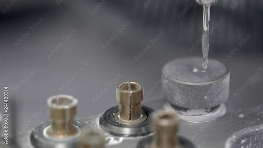Closeup view at moving hi-speed spindle of dental milling machine Closeup view at moving hi-speed spindle of dental milling machine