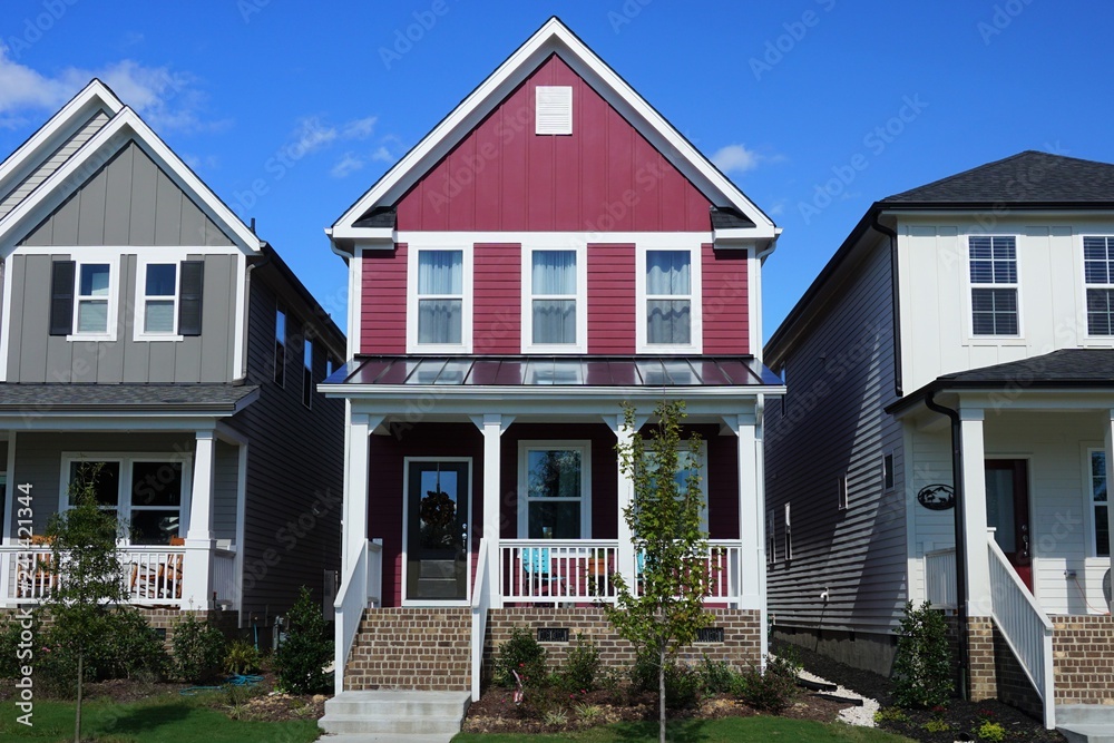 Two story, red, row house in a suburban neighborhood in North Carolina