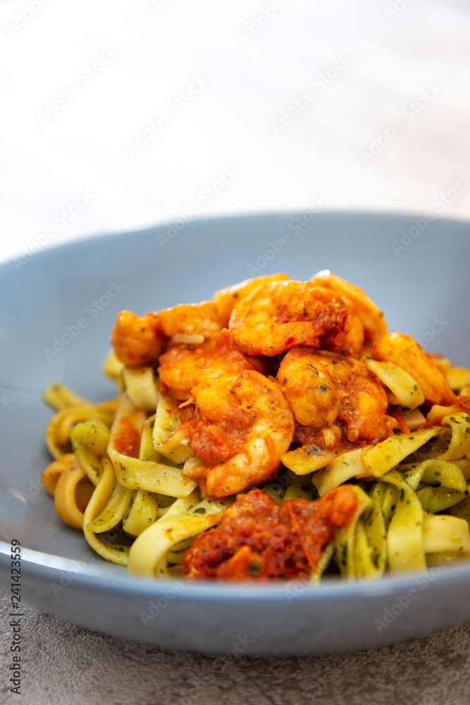 Cooked pasta with peeled shrimp, coconut milk sauce and broccoli Cooked pasta with peeled shrimp, coconut milk sauce and broccoli