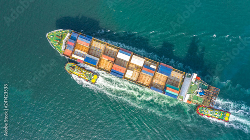 Container ship in export and import business logistics and transportation. Cargo and container box shipping to harbor by crane. Water transport International. Aerial view and top view.