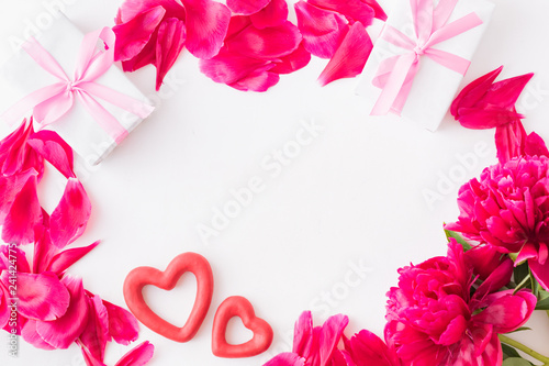 Valentines day composition with red peonies and gift box on a light background