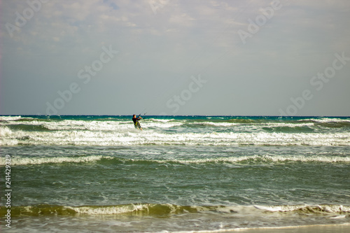 Solo Kite Surfer Riding the Waves in Mediterranean Waters Extreme Adventure Sports in Scenic Coastal Setting