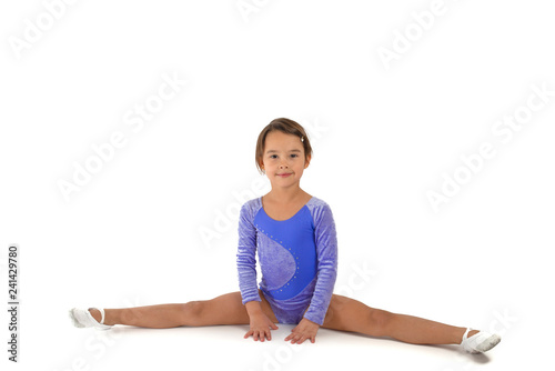 girl is engaged in gymnastics. child sitting on the splits. isolated on a white background