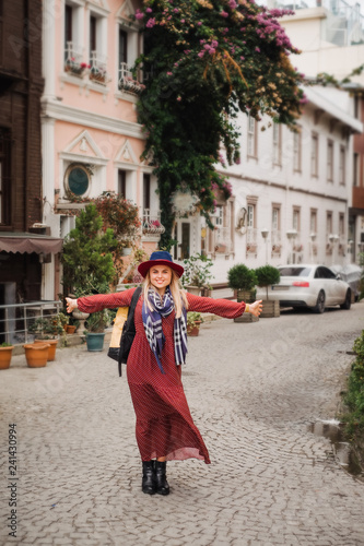 Beautiful woman in hat and dress walking in Istanbul street, Turkey