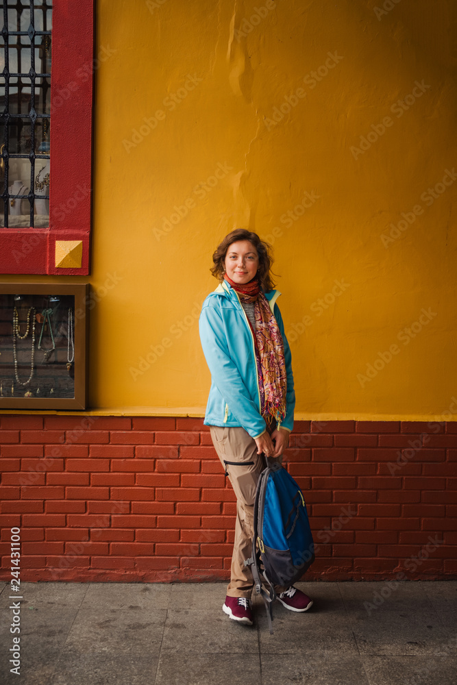 Woman stay near yellow wall background in Istanbul