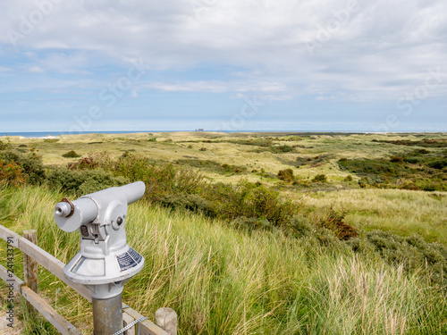 Coin operated binoculars overlooking dunes of Het Oerd on West Frisian island Ameland towards North Sea, Netherlands photo