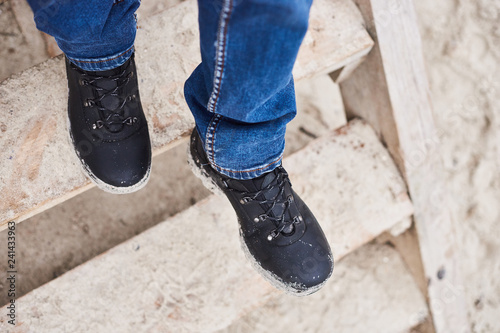 Close up Men wear jeans and shoe are walk down the wooden stairs. lifestyle men fashion - Image