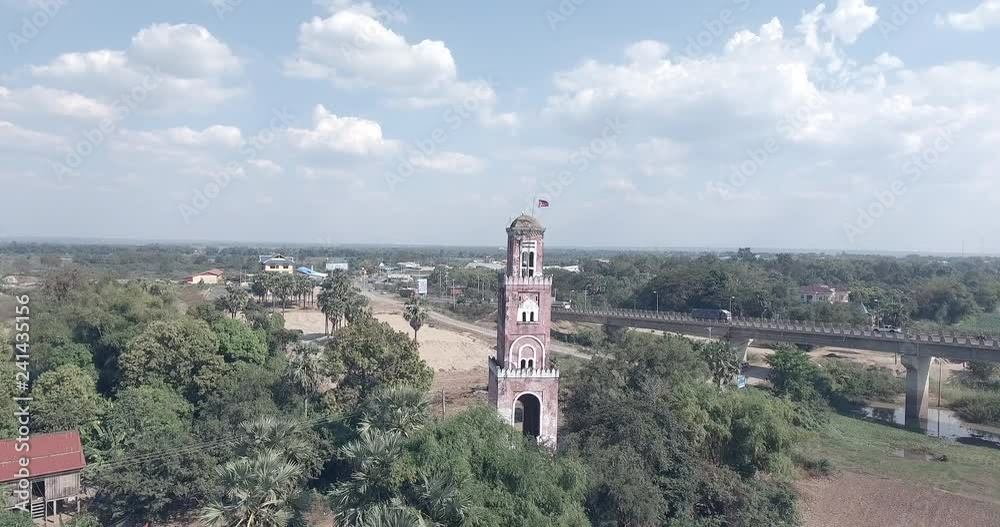 aerial drone shot past the colonial french watchtower near a concrete bridge aerial drone shot past the colonial french watchtower near a concrete bridge