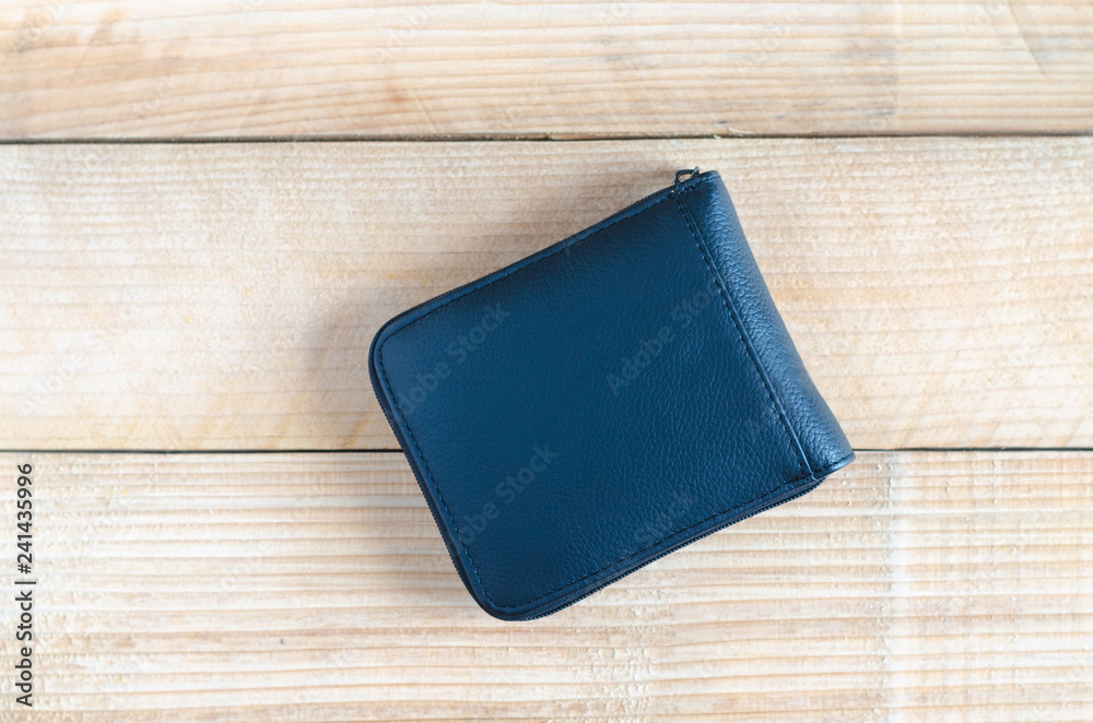 modern black leather wallet on wooden table background. wealth, saving, money, finance and investment concept. modern black leather wallet on wooden table background. wealth, saving, money, finance and investment concept.