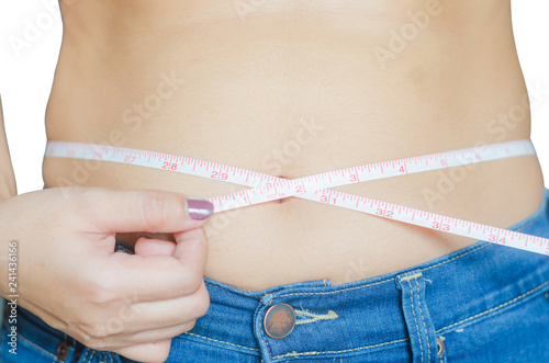 asian woman use measure tape to measuring belly fat for check her body and healthy.