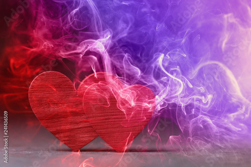 Two red hearts in colored smoke