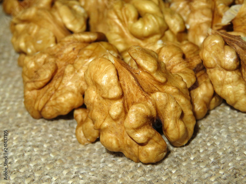 Walnuts kernels on burlap close-up. Peeled nuts, healthy eating concept