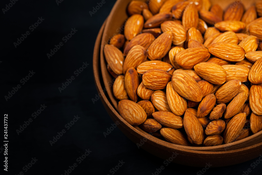 Almonds Nuts in the Bowl Background. Selective focus. Almonds Nuts in the Bowl Background. Selective focus.