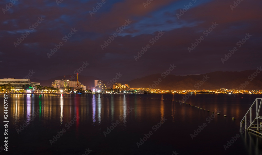 Night view on the gulf of Aqaba from the central beach of Eilat - famous tourist resort and recreational city in Israel