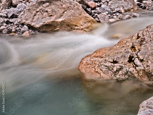 Ice Cold Lake with long exposure water movement and HDR effect to stones