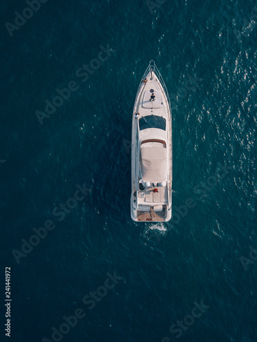 aerial drone top shot of a luxurious yacht on the sea © SmallWorldProduction