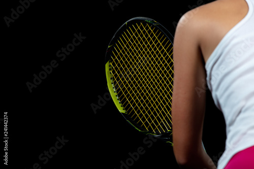 Beautiful girl tennis player with a racket on dark background with lights © FS-Stock