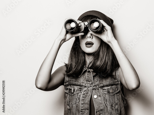 Portrait of young style hipster girl with binoculars . Image in black and white color style