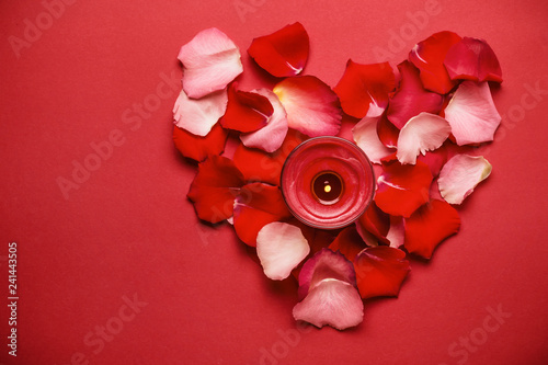 Love is a romantic concept. Heart of rose petals and candle