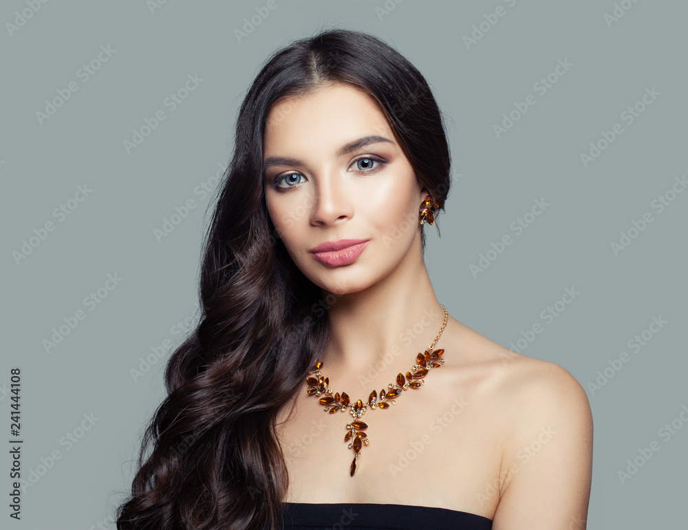 Young woman fashion model with long hair and amber necklace, portrait Young woman fashion model with long hair and amber necklace, portrait